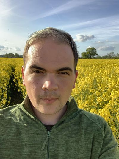 A profile picture of Chris standing in a field